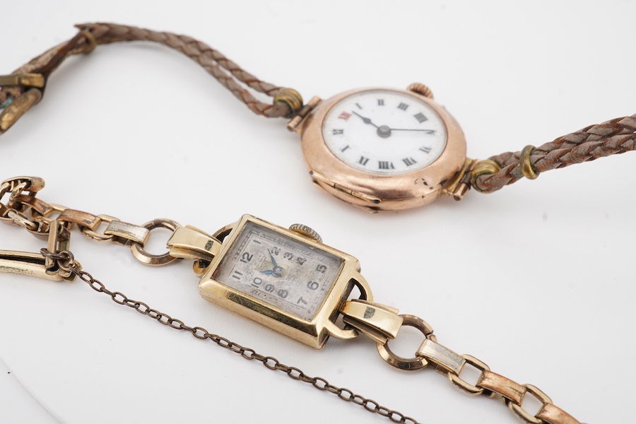 Two lady's 9ct gold manual wind wrist watches, on on fabric strap, the other on gold plated strap.